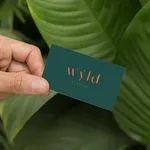 green business cards on recycled paper