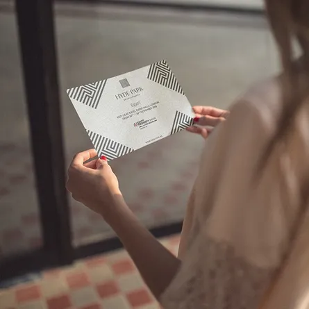 holding a printed a6 flyer