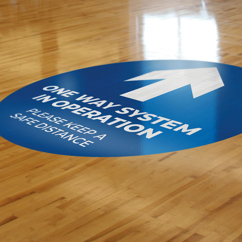 One way Round sticker applied to wood floor One way Round sticker applied to wood floor